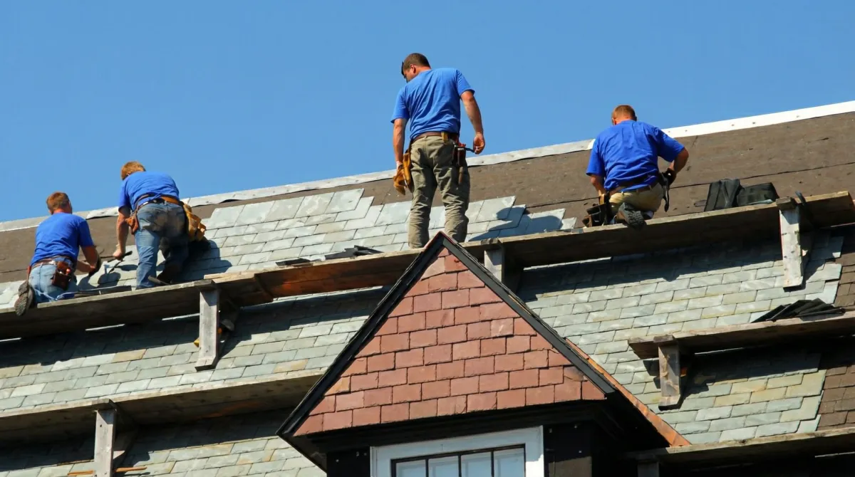 Roof replacement in progress with a team of professional contractors installing new shingles on a residential home in Chula Vista, CA